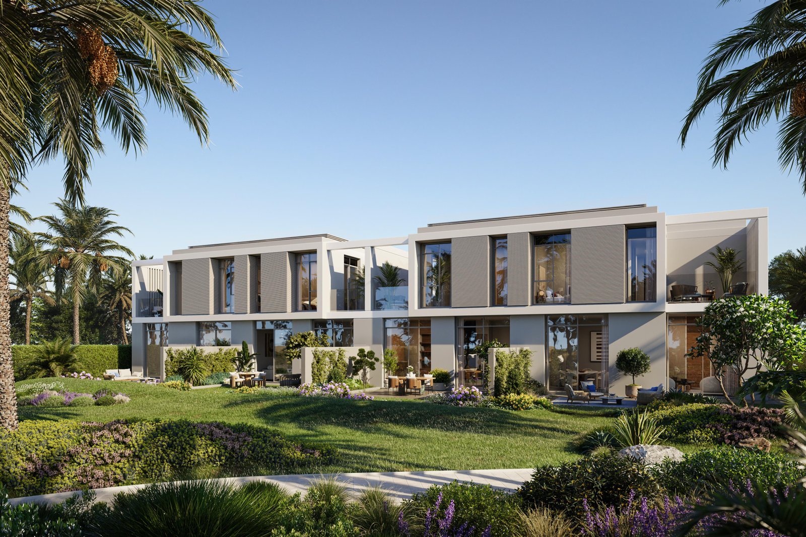 Shaded green corridor with date palms and ghaf trees connecting residential villages at Fay Valley, Masdar City.